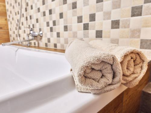 a white bath tub with towels sitting on it at Apartment Marika 2 by Interhome in Cerny Dul