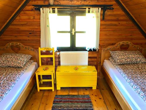 a room with two beds and a cross on the window at Vila Tornik in Zlatibor