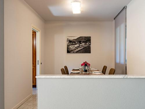 a dining room with a table and chairs at Apartment Stazione by Interhome in Porlezza