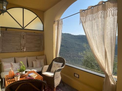 a room with a large window with a table and chairs at Holiday Home Casa Norvegia by Interhome in Valloria