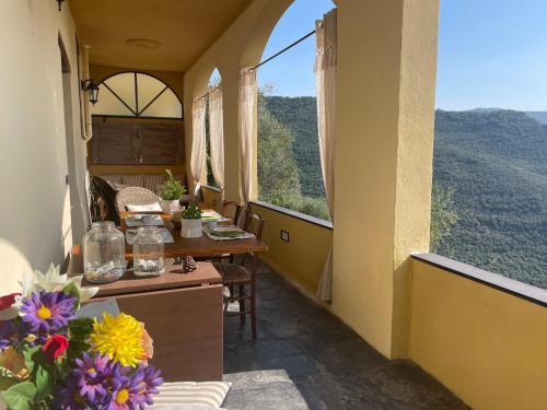 a balcony of a house with a table and flowers at Holiday Home Casa Norvegia by Interhome in Valloria
