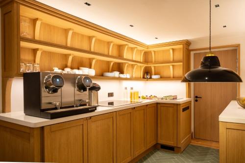 a kitchen with wooden cabinets and a microwave at Esteem Tour Eiffel in Paris