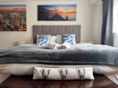 a bedroom with a large bed with towels on it at Canary Wharf - Luxury Apartments in London