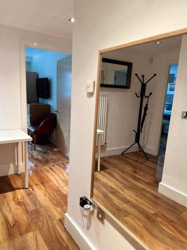 a mirror on the wall of a living room at Canary Wharf - Luxury Apartments in London