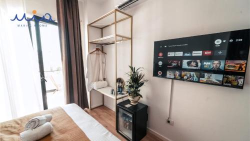 a bedroom with a bed and a large window at Mia Marine Rooms in Himare