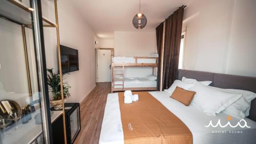 a bedroom with a large white bed in a room at Mia Marine Rooms in Himare