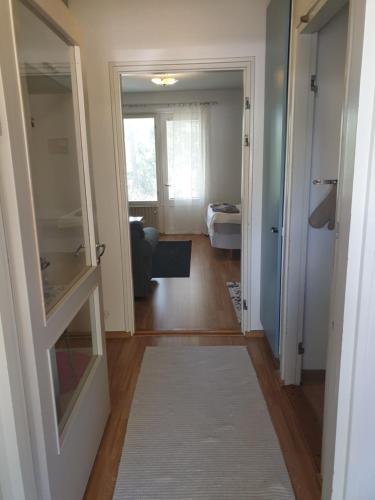 a hallway with a door open to a living room at Studio Aalto in Taalintehdas