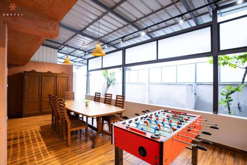 a large room with a table and a foos ball at Zostel Kochi (Ernakulam) in Ernakulam