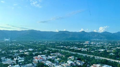 an aerial view of a city with mountains in the background at Centaurus Apartment Mountain View Two Bedroom in Islamabad