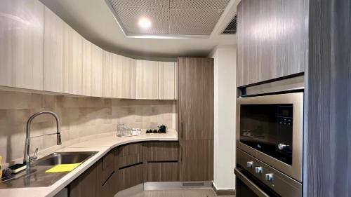 a kitchen with a sink and a stove at Centaurus Apartment Mountain View Two Bedroom in Islamabad