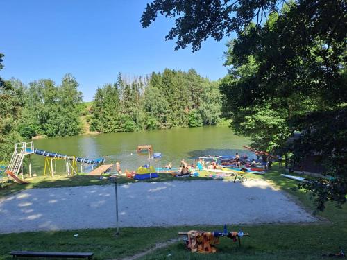 a group of people at a playground in a lake at Penzion Diana in Kunžak