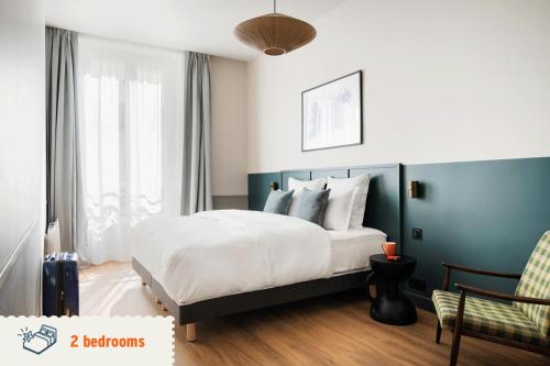 a bedroom with a bed and a large window at Edgar Suites Saint-Lazare - Amsterdam in Paris