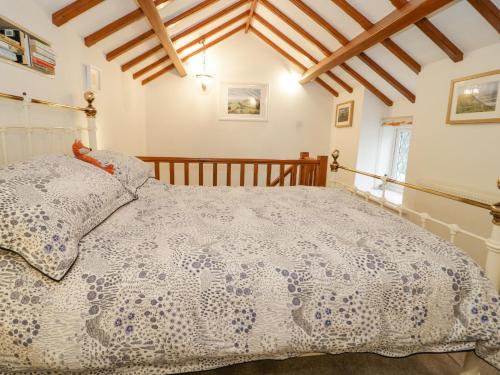 a bedroom with a large bed in a room at The Little White Cottage in Llanferres
