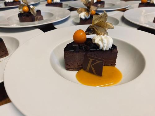 a piece of chocolate cake on a plate on a table at Das gemütliche Dorfhotel Kaltenhauser in Hollersbach im Pinzgau