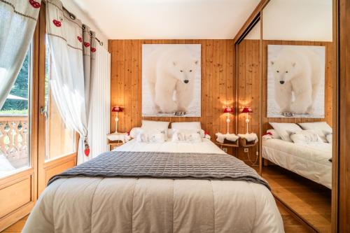a bedroom with two posters of polar bears on the wall at Au Rêve Savoyard 5 in Morillon