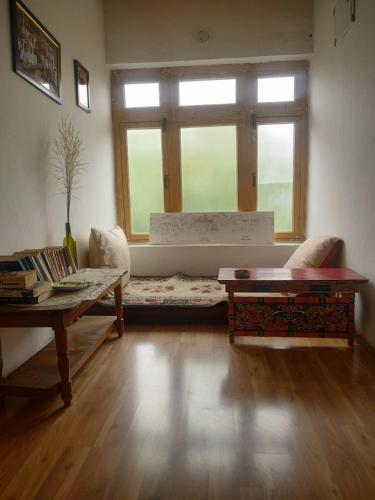 a living room with a couch and a window at Skara Shangara Homestay in Leh