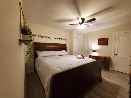 a bedroom with a large bed with a ceiling fan at Room Near Downtown UofL,Airport&ExpoCenter in Louisville