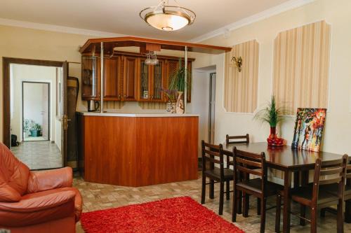 a kitchen and dining room with a table and chairs at Джерело in Kamianets-Podilskyi