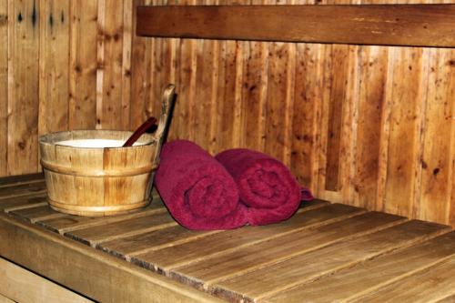 a pair of towels and a bucket in a sauna at Spark Residence Hotel in Sharjah