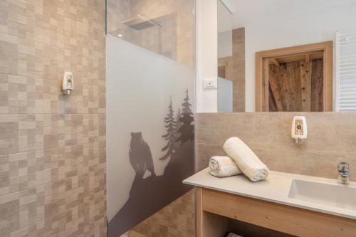 a bathroom with a sink and a mirror at Miraval Hotel in Coredo