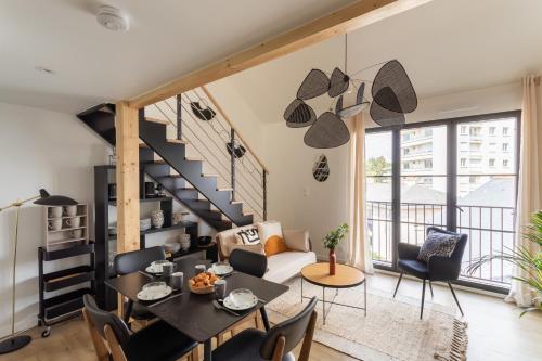 - un salon avec un escalier, une table et des chaises dans l'établissement Le Saint Martin Bis - Bel appartement moderne et confortable, à Rennes