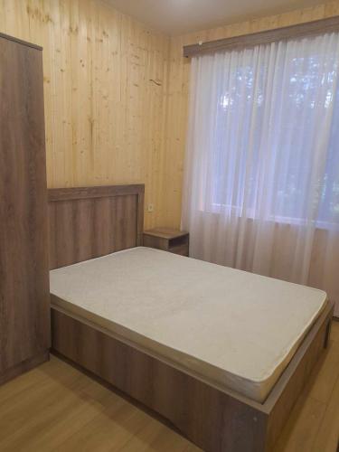 uma cama grande num quarto com uma janela em Mariam's Cottage em Kobuleti
