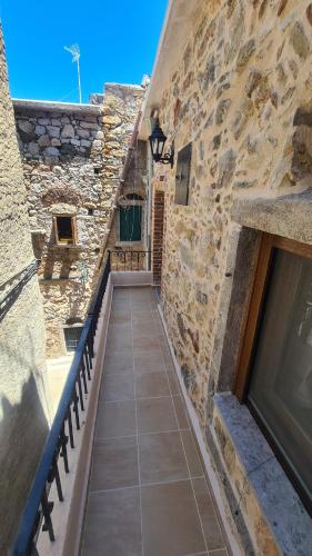 a stone building with a staircase leading to a door at Olympus in Olýmpoi