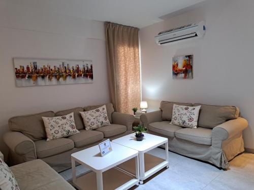 a living room with a couch and a table at Albert's apartment St Lazarus 402 B - First Floor in Larnaka
