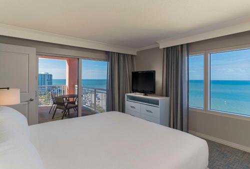a bedroom with a bed and a view of the ocean at Hyatt Regency Clearwater Beach Resort & Spa in Clearwater Beach