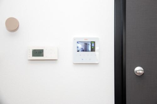 a door with an electrical device on the wall at Apartmani Kac in Karlovac