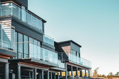 an exterior view of a building with glass balconies at HavsVidden Resort in Geta