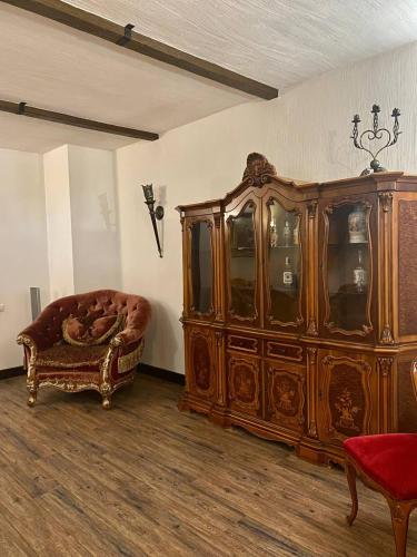 a large wooden cabinet and a couch in a room at ЕДБУРГ Готельно-ресторанний комплекс in Nizhnedneprovsk