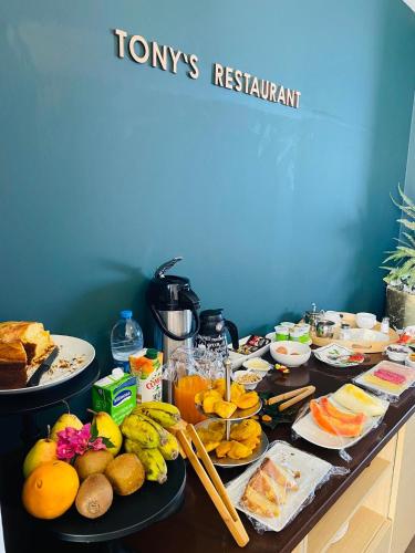 a table topped with lots of different types of food at Fogo Boutique Hotel in São Filipe