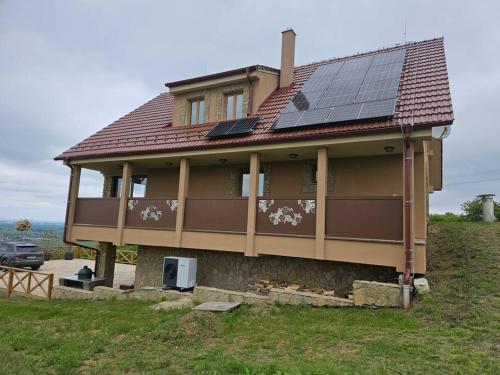 a house with solar panels on top of it at Vinársky dom u kríža in Vrádište