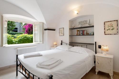 a bedroom with a large white bed and a window at Oceane Paradise - Luigi 14 in Levanto