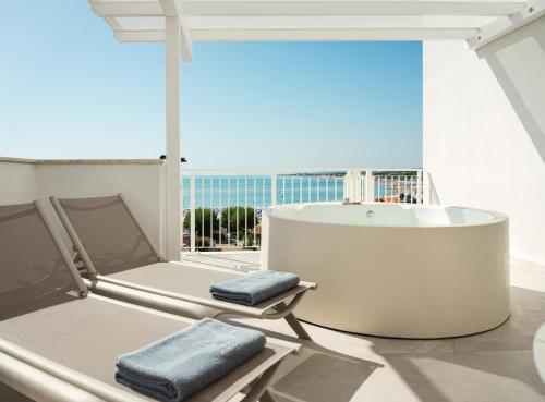 a bath tub on a balcony with a view of the ocean at View Place & Spa in Numana