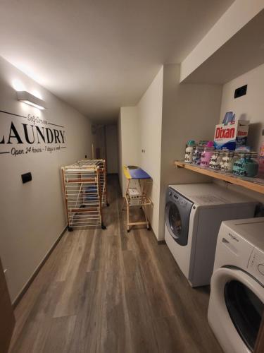 a laundry room with a washing machine and a washer at K2 home in Bormio