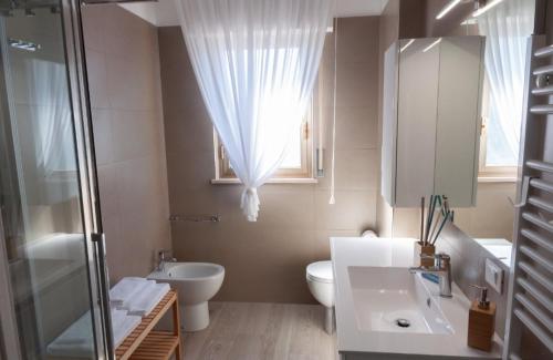 ein Bad mit einem Waschbecken, einem WC und einem Fenster in der Unterkunft Novatek Apartment B&B in Chieti