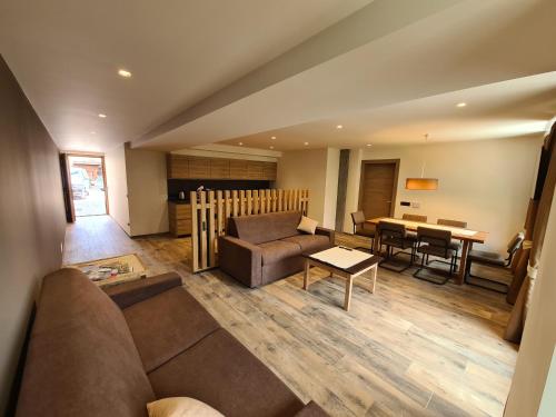 a living room with a couch and a table at K2 home in Bormio