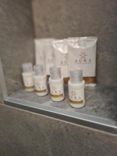 a shelf with four bottles on a counter with a bag at K2 home in Bormio