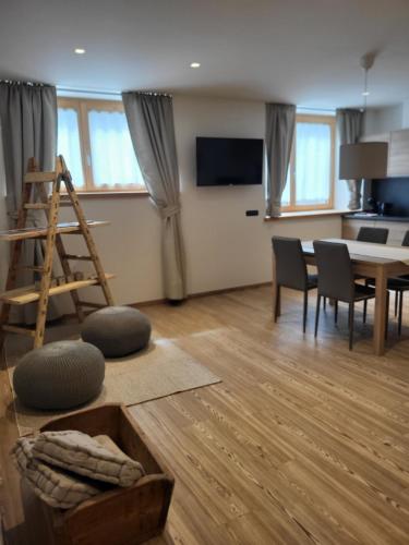 a living room with a table and a dining room at K2 home in Bormio