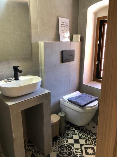 a bathroom with a sink and a toilet at Solo traveler in Ermoupoli