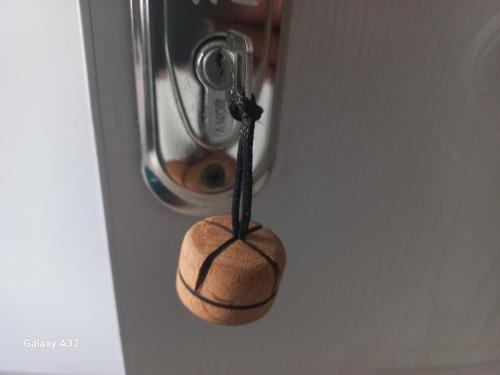 a wooden object is hanging from a hook on a door at Ninama in Mestia
