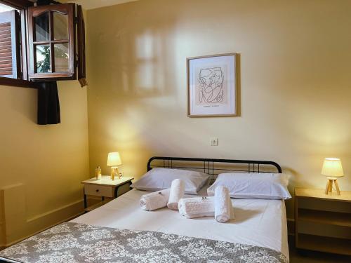 a bedroom with a bed with two white pillows at Theo's Apartment in Argostoli