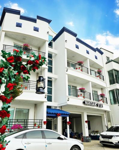 a white car parked in front of a building at Naksanstay in Yangyang