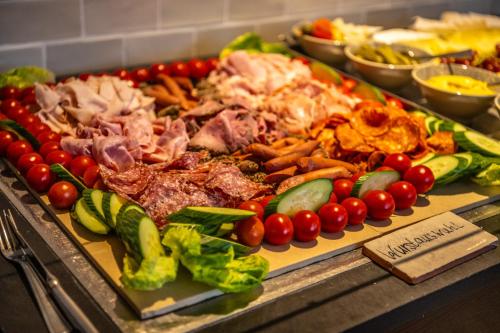 a tray of different types of vegetables on a buffet at BollAnts Spa im Park in Bad Sobernheim