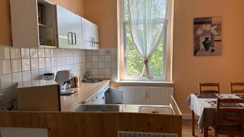 eine Küche mit einem Waschbecken und einem Fenster in der Unterkunft Appartment First in Duisburg