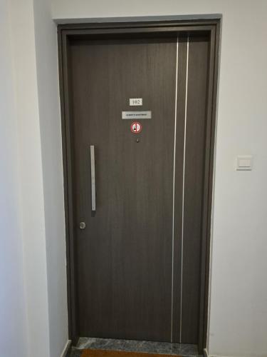 a wooden elevator door with a sign on it at Albert's apartment St Lazarus 402 B - First Floor in Larnaka