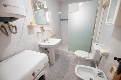 a white bathroom with a sink and a toilet at Destino De Sol De Los Alcazares in Los Alcázares