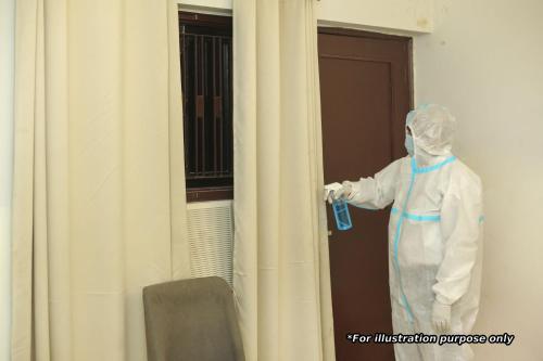 a man in a whitensicsnsicsnsics suit standing outside a door at POP HOME Rozia Homestay in Thanna Mandi